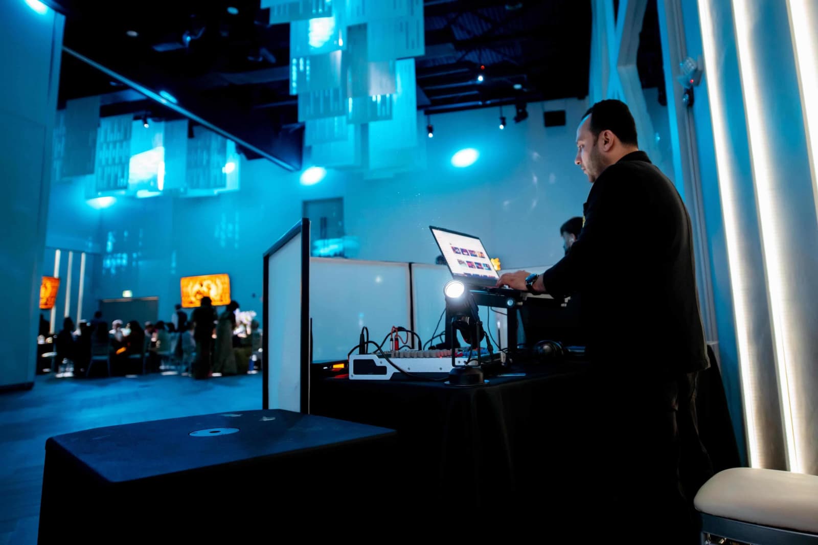 DJ RP performing live behind the booth at an upscale event