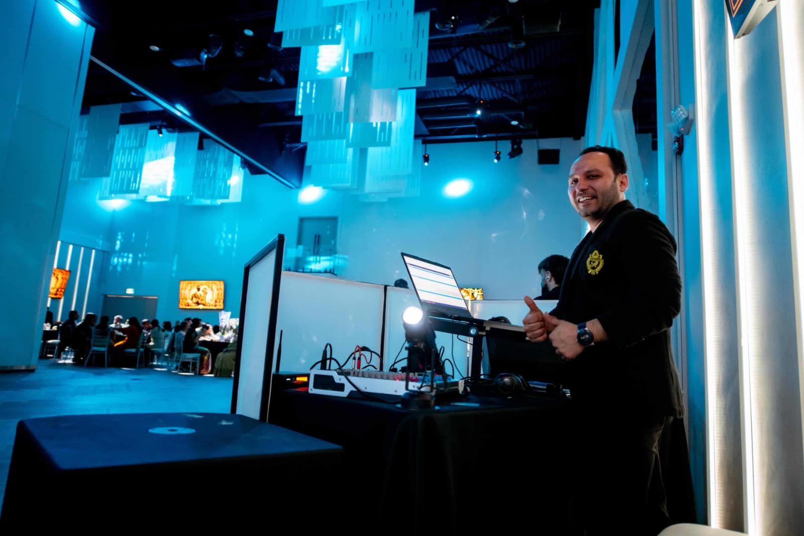 DJ RP live at a luxury banquet hall with blue ambient lighting